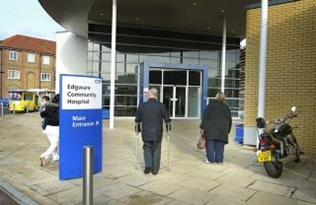 Two people walking in the main entrance to Egdeware Community Hospital